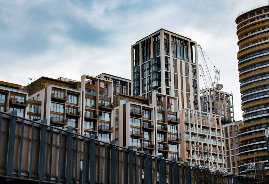 New apartment towers rising beside a construction crane
