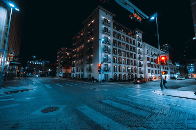 Balconied buildings at a downtown San Antonio corner at night