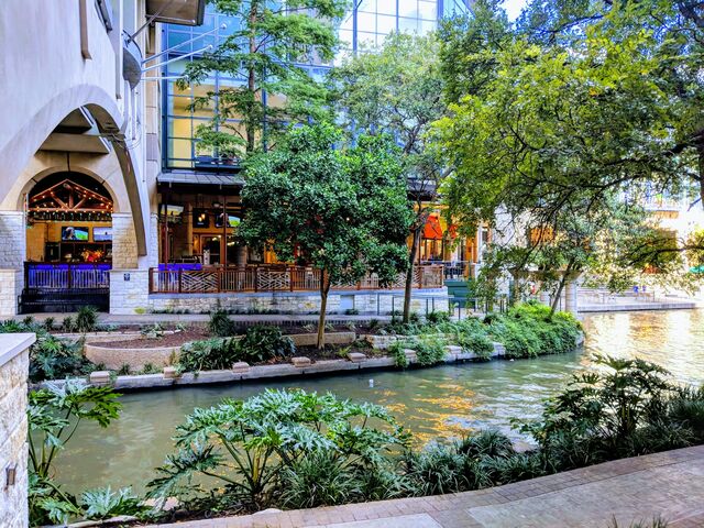 Landscaped canal and storefronts along the San Antonio River Walk