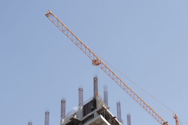 Tower crane above rebar columns on a high-rise construction site