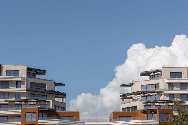 Two modern apartment buildings under an open sky