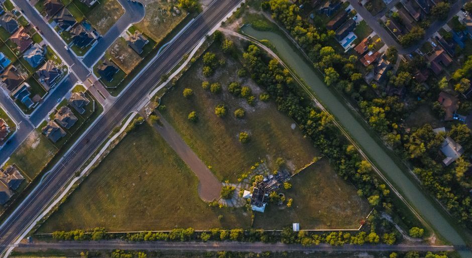 Aerial view of new suburban streets meeting open land