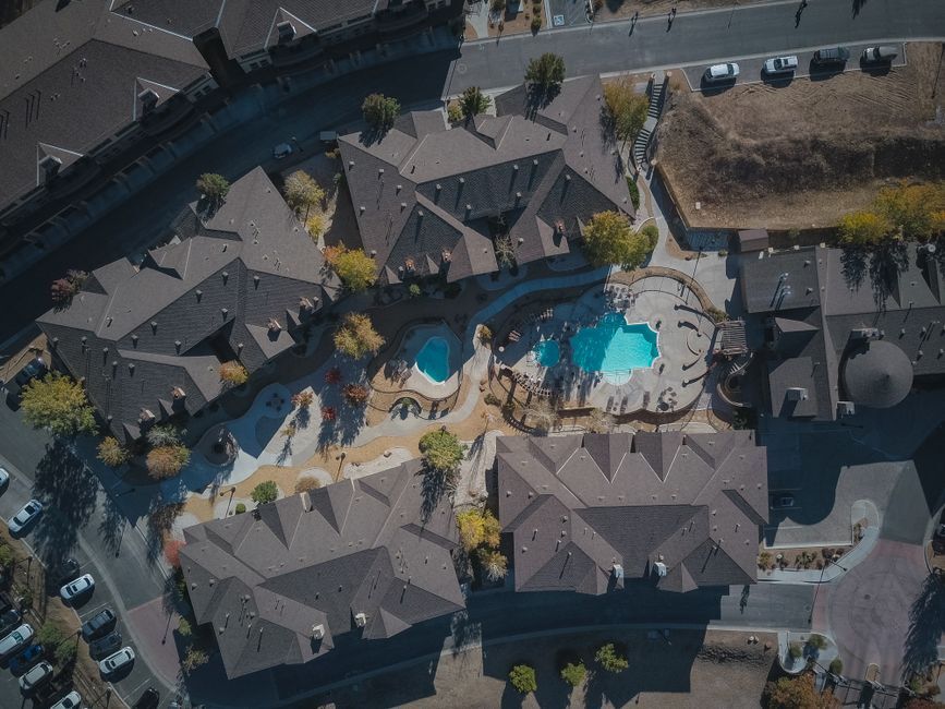Top-down view of garden apartment courtyards with pools
