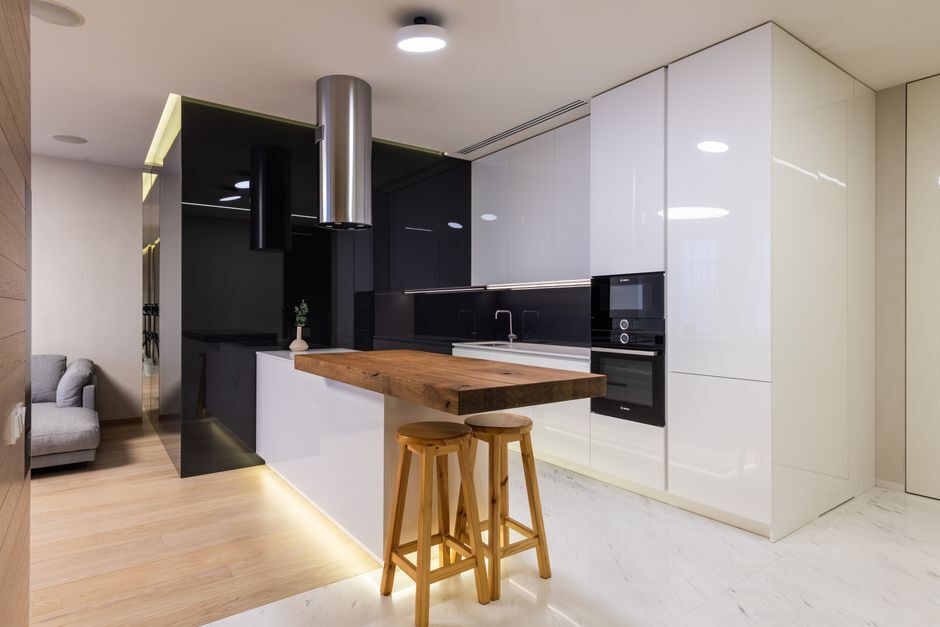 Modern apartment kitchen with glossy cabinets
