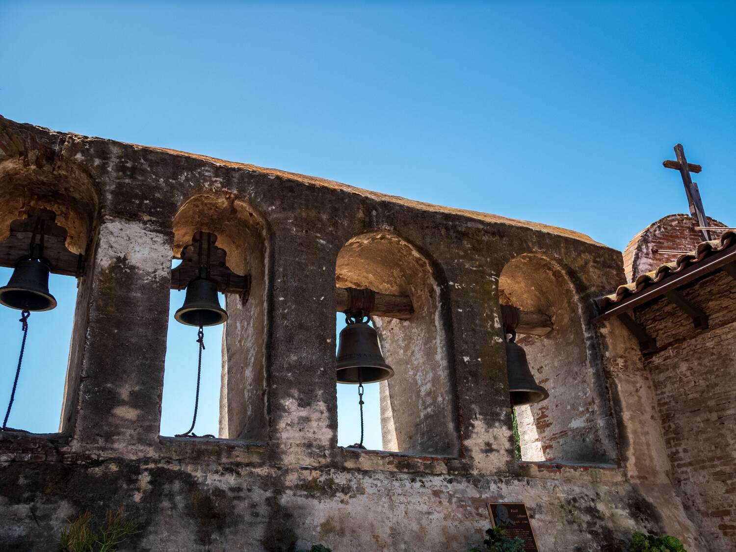 Bells hanging in the stone arches of a San Antonio mission wall