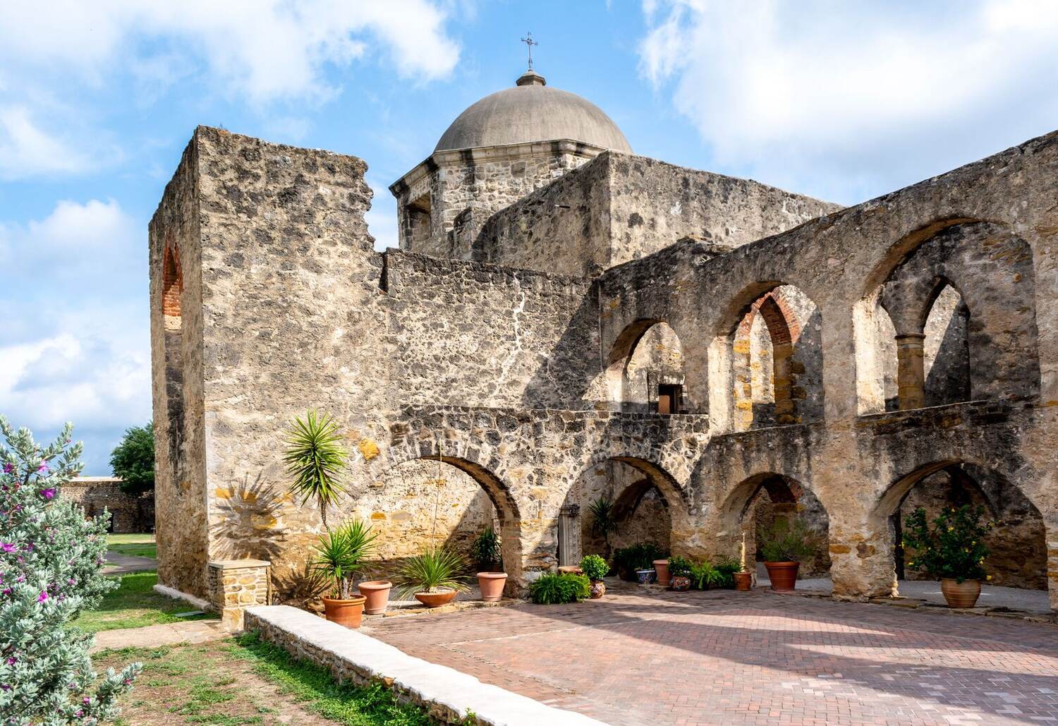 Stone arches and courtyard garden at Mission San Jose