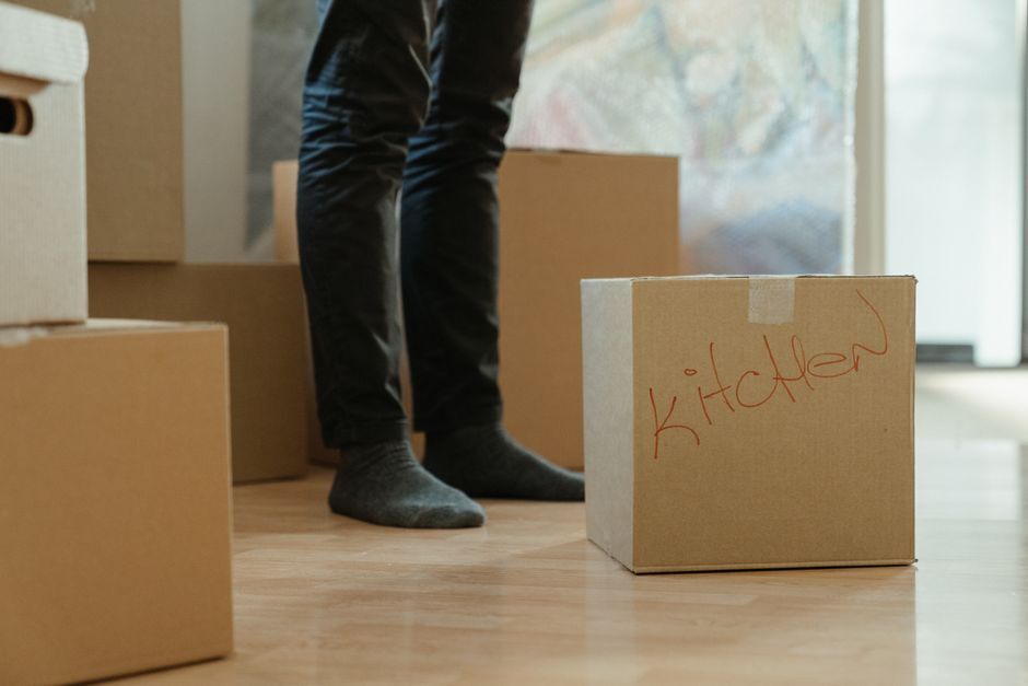 Moving boxes stacked on the floor of a new home