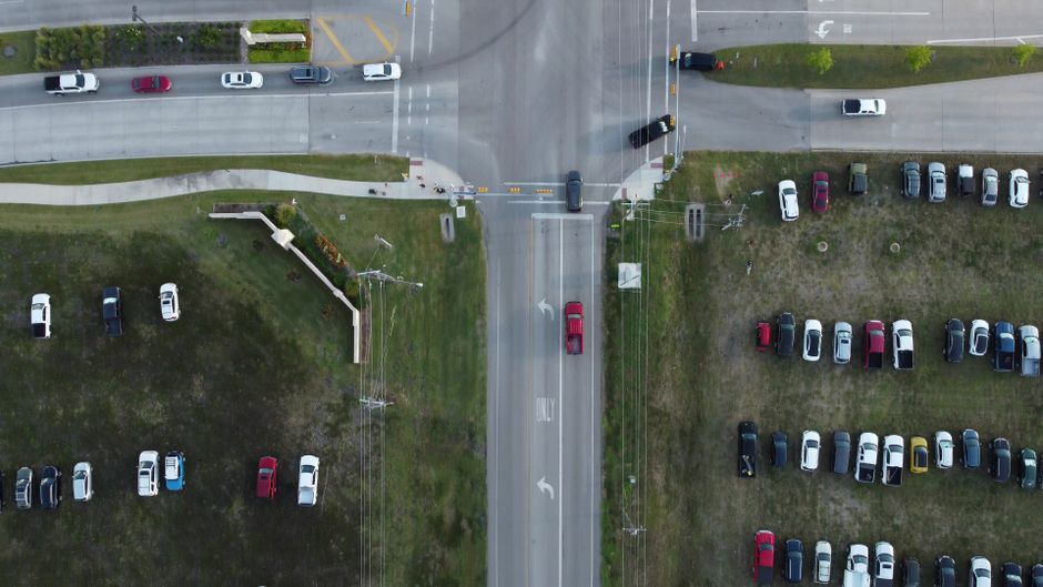 Aerial view of a suburban crossroads and parking areas