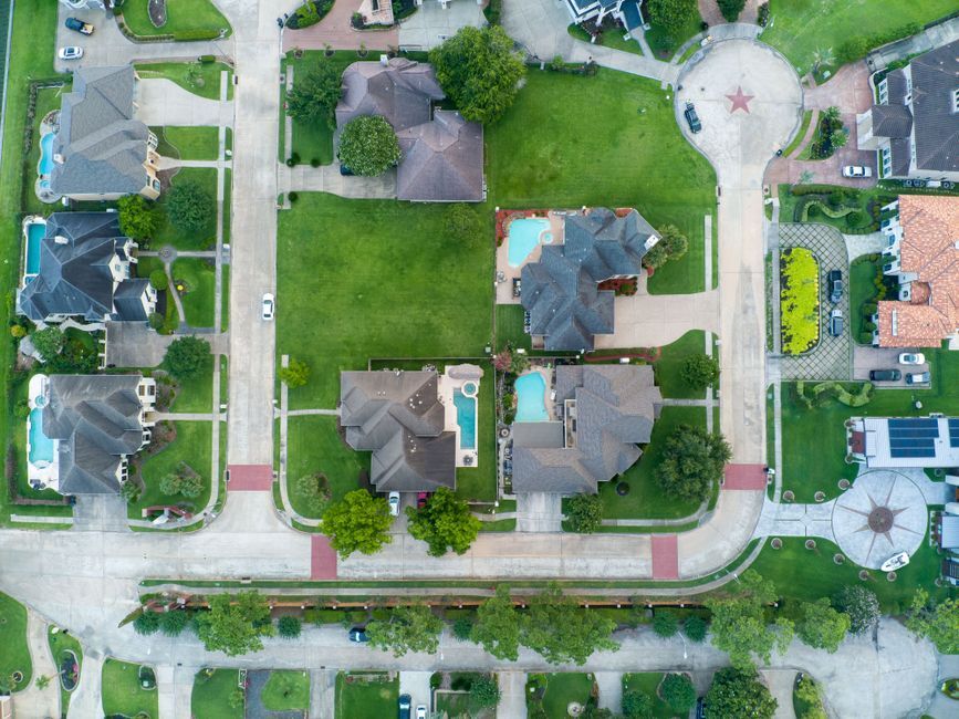 Aerial view of suburban homes with backyard pools