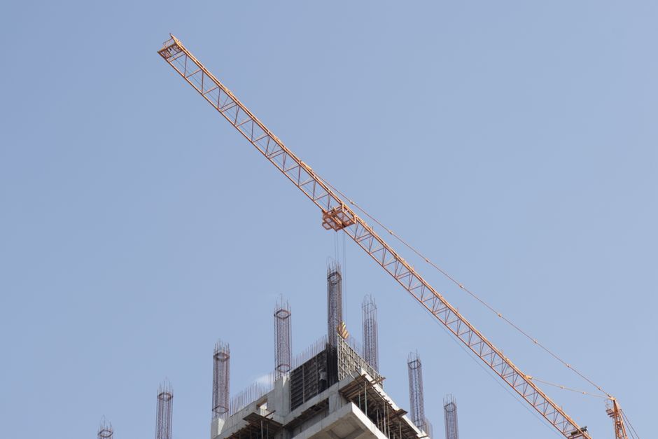 Tower crane above rebar columns on a high-rise construction site