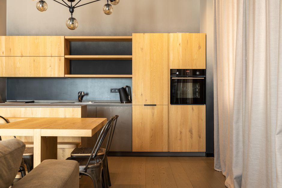 Apartment kitchen with wood cabinets and built-in oven